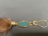 an image of a keychain with a fur ball on it