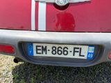 a small red car with a white stripe on it