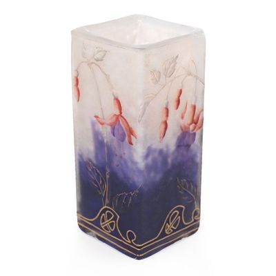 a white candle with a blue and purple design on it