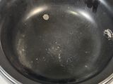 an old black frying pan sitting on top of a white counter