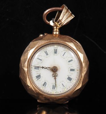 a gold pocket watch with roman numerals on the face