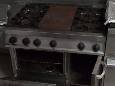 a stove with a pan on top of it in a kitchen