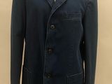 the jacket is blue and has buttons on the front of it