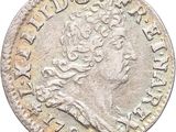 une pièce d'argent portant une tête de femme
