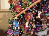 a very colorful christmas tree that is on display