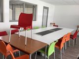 many chairs around a table in a conference room