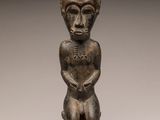 a small statue of a man with a hat on his head