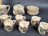 many cups and saucers that are sitting on a table