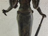 statue of a woman holding a sword and a bird on her arm