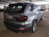the back of a silver bmw suv parked in a parking lot