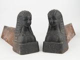 pair of black stone busts of a woman and a man