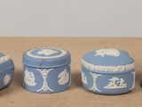 three blue and white containers sitting on a table