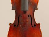 an old violin with a bow hanging from it ' s back