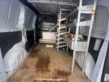 a white van with a ladder in the back of it