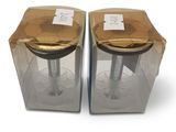 two clear boxes with gold lids on each of them