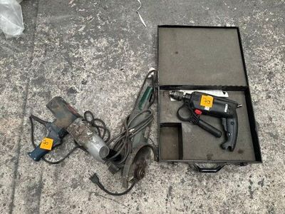 a box with tools on the ground next to a corded cord