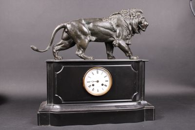 a statue of a lion on top of a clock