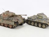 two toy tanks sitting next to each other on a white surface
