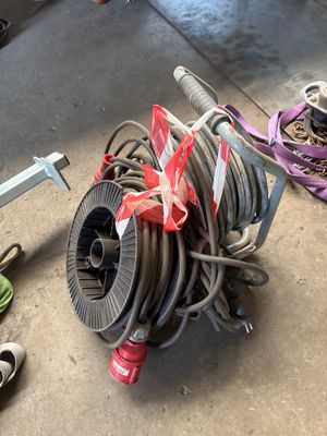 a hose that is sitting on the ground next to a pair of shoes