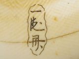 a close up of a white vase with writing on it