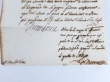 an old piece of paper with writing on it sitting on a table