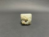 a close up of a piece of white jade on a table