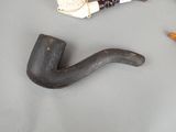 a pipe and a cigarette holder on a table