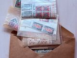 a brown envelope with a bunch of stamps inside of it
