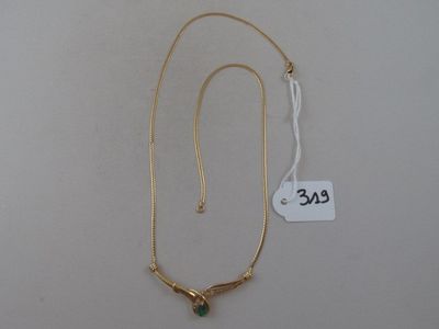 gold plated necklace with a green stone on a gold chain