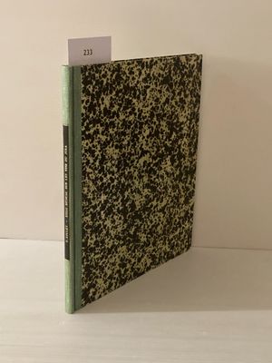 Le livre est posé sur une table près d'un mur blanc.