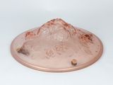 a pink plate with a mountain in the middle of it
