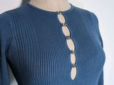 the top of a woman ' s sweater with buttons on a mannequin mannequin mannequin mannequin mannequin mannequin manne