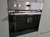 an oven that is built into the wall in the kitchen