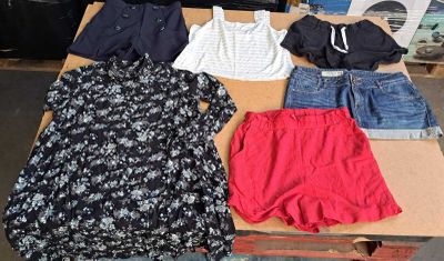 a table that has a lot of clothes on it
