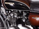 a brown and black motorcycle parked in a garage