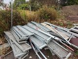 piles of metal and wood sit on the side of a road