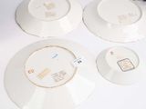three plates and a bowl sitting on a table