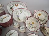 a lot of plates and cups that are on the table