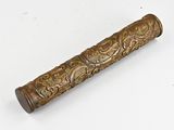 an old wooden handle with a design on it on a white surface