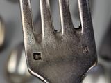 a fork that is sitting in front of a bunch of spoons