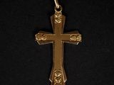 une croix dorée ornée de roses sur fond noir