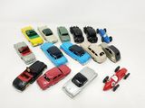 a lot of toy cars that are on a white surface