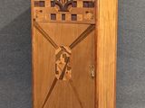 a wooden cabinet with a flower design on it