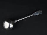 a spoon that is sitting on top of a black table