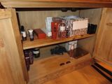 a wooden cabinet with a lot of items on it