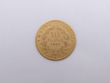 an image of a gold coin on a white surface with a white background