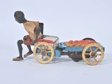 a figurine of a man with a cart of fruit
