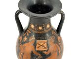 a black and orange vase sitting on a white surface