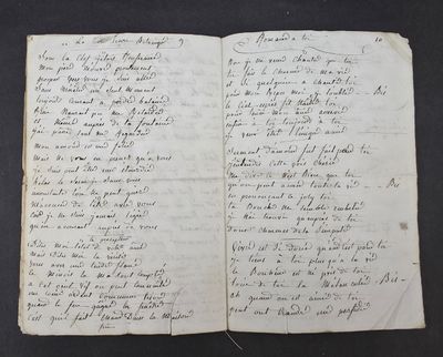 an old book with writing on it sitting on top of a table