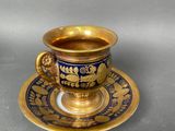 a cup and saucer on a saucer on a table